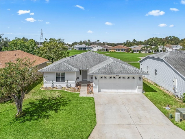 ranch-style home featuring a garage and a front yard