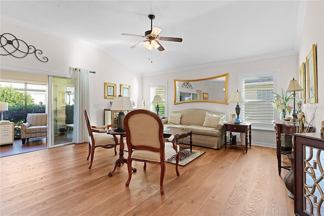 living room with light hardwood / wood-style floors, vaulted ceiling, ceiling fan, and crown molding