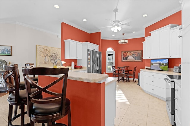 kitchen featuring white cabinetry, crown molding, and stainless steel appliances