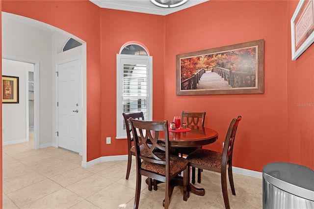 dining room with ornamental molding and light tile patterned flooring