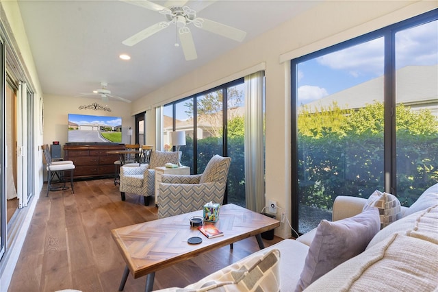 sunroom / solarium featuring ceiling fan