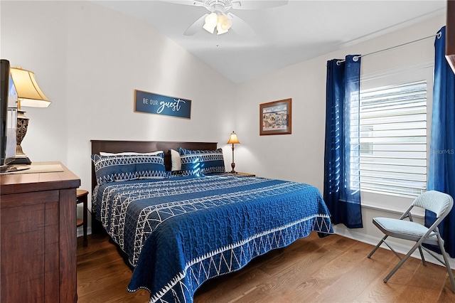 bedroom featuring hardwood / wood-style flooring, ceiling fan, and vaulted ceiling