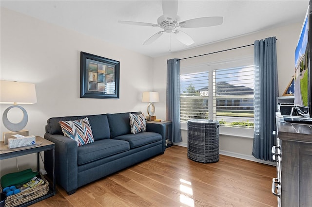 living room with hardwood / wood-style flooring and ceiling fan