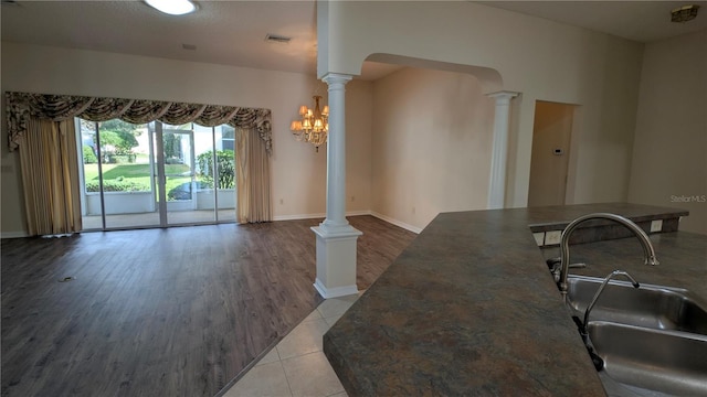 interior space with sink, a notable chandelier, and light wood-type flooring