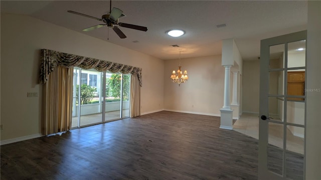 unfurnished room featuring a textured ceiling, dark hardwood / wood-style floors, ceiling fan with notable chandelier, and decorative columns