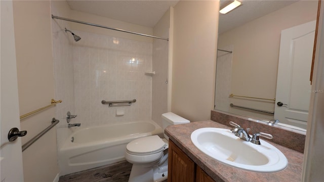 full bathroom with vanity, wood-type flooring, a textured ceiling, and  shower combination