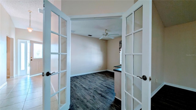 hallway with wood-type flooring and french doors