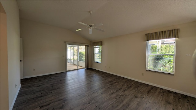 spare room featuring lofted ceiling, plenty of natural light, dark wood-type flooring, and ceiling fan