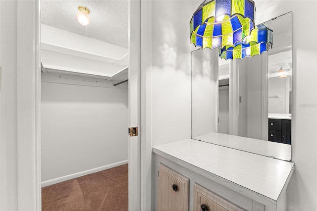 spacious closet featuring dark colored carpet