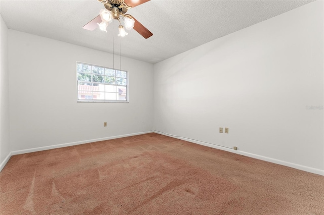 carpeted spare room with a textured ceiling and ceiling fan