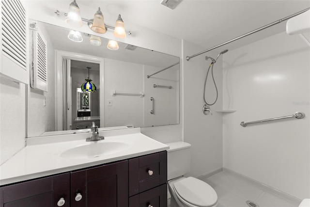 bathroom featuring toilet, vanity, a shower, and tile patterned flooring