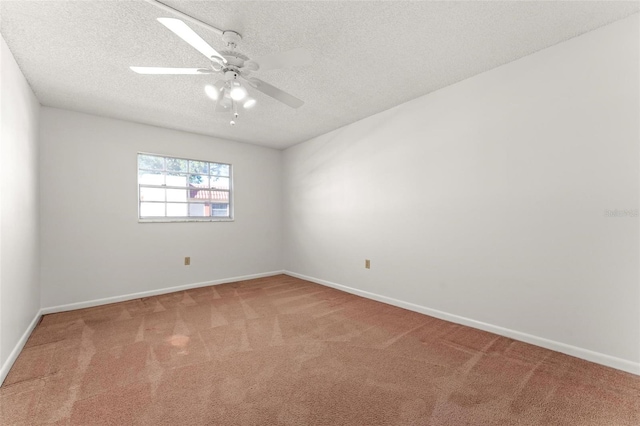 unfurnished room with a textured ceiling, carpet, and ceiling fan