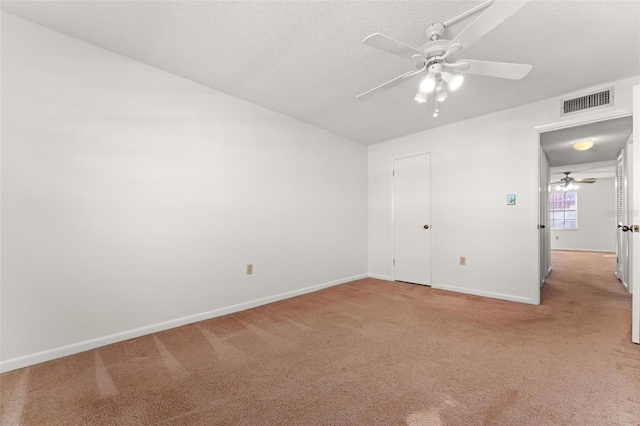 unfurnished bedroom featuring a closet, a textured ceiling, carpet flooring, and ceiling fan