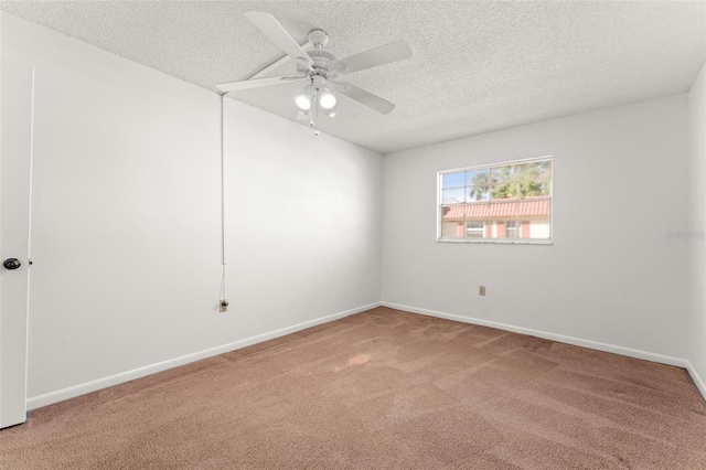 unfurnished room with ceiling fan, a textured ceiling, and carpet floors