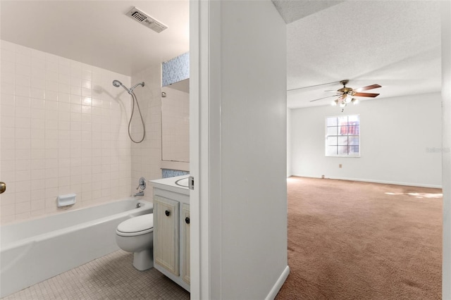 full bathroom featuring tiled shower / bath, vanity, toilet, and ceiling fan