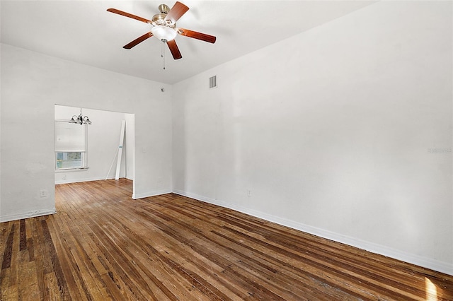 empty room featuring hardwood / wood-style floors and ceiling fan with notable chandelier