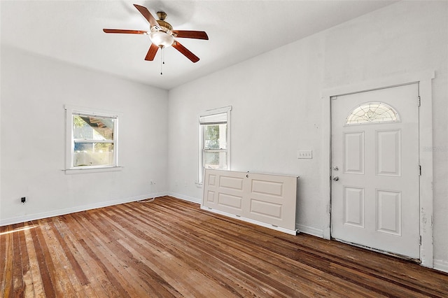 foyer entrance featuring dark wood-type flooring, plenty of natural light, and ceiling fan