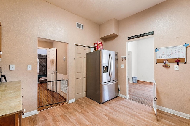 kitchen featuring stainless steel fridge and light wood-type flooring