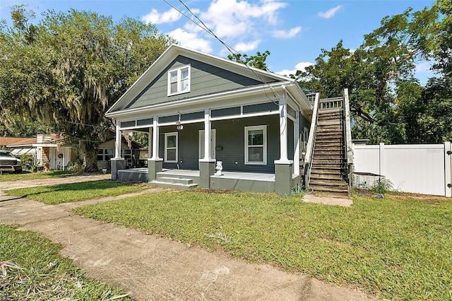 view of front of property with covered porch and a front lawn