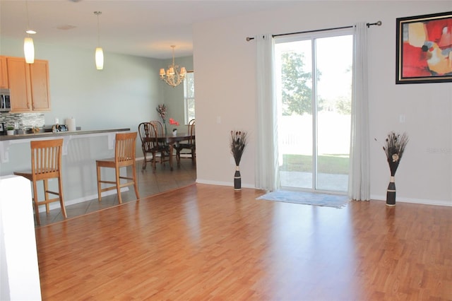 1681 Strathmore Cir, Mount Dora, FL 32757 - living room with a chandelier and light wood finished floors