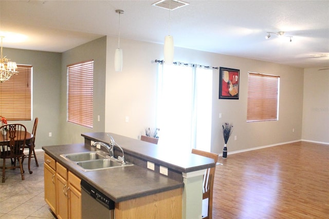 1681 Strathmore Cir, Mount Dora, FL 32757 - kitchen with stainless steel dishwasher, dark countertops, light brown cabinets, a chandelier, and open floor plan