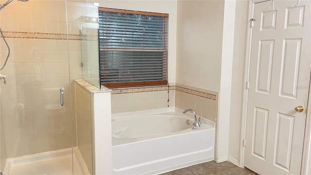 1681 Strathmore Cir, Mount Dora, FL 32757 - bathroom with a shower stall, a bath, and tile patterned flooring