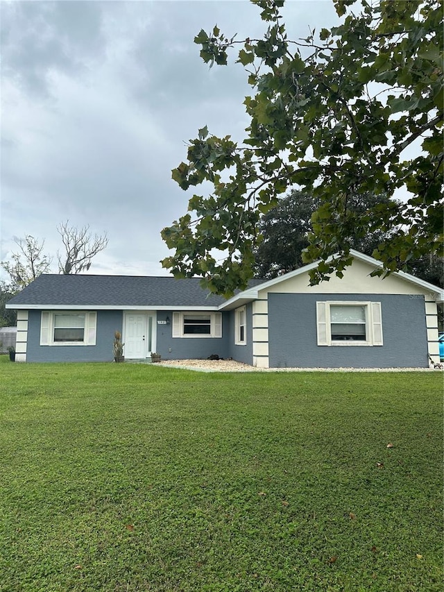 ranch-style home featuring a front yard