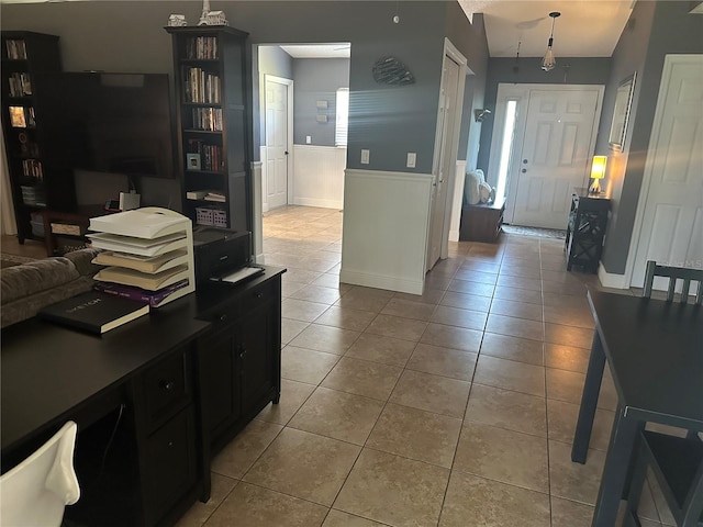 kitchen with decorative light fixtures, lofted ceiling, and light tile patterned floors