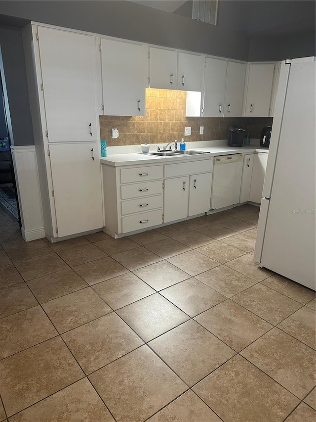 kitchen with decorative backsplash, white appliances, sink, and white cabinets