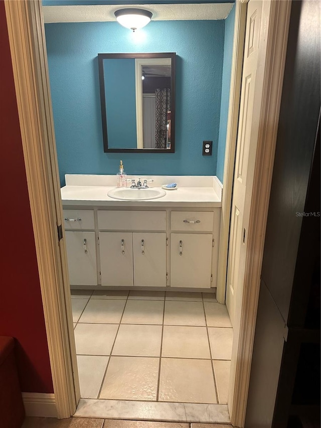 bathroom featuring tile patterned floors, vanity, and a textured ceiling