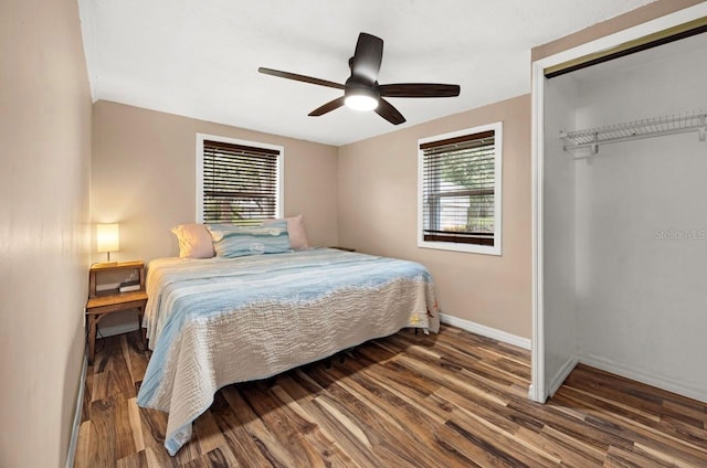 bedroom with hardwood / wood-style flooring, ceiling fan, and a closet