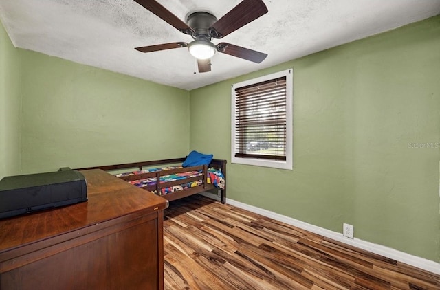 bedroom featuring ceiling fan, a textured ceiling, and hardwood / wood-style floors