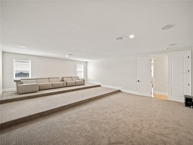 unfurnished living room with a textured ceiling and carpet