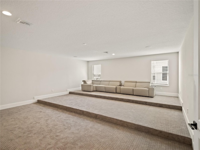 unfurnished living room with carpet and a textured ceiling