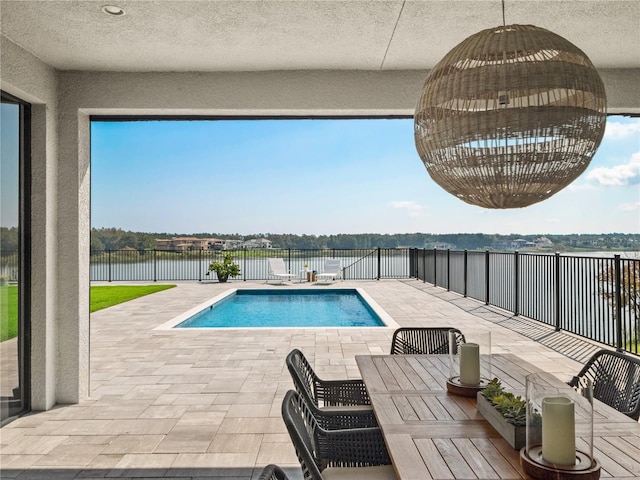 view of swimming pool featuring a patio area and a water view