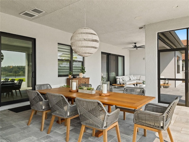 interior space featuring ceiling fan, a textured ceiling, and plenty of natural light