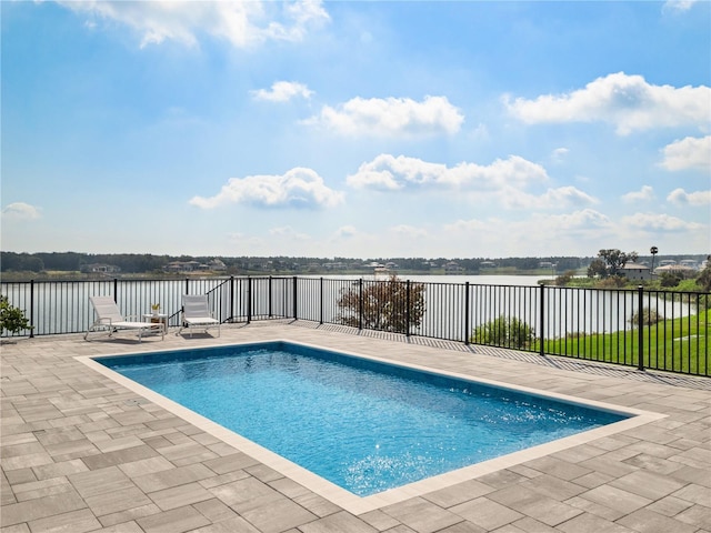 view of swimming pool featuring a water view and a patio