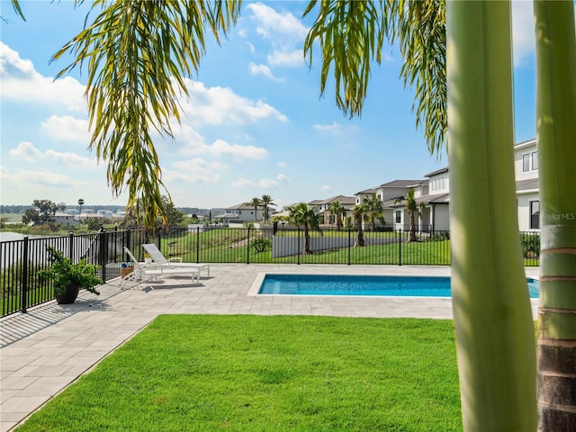 view of pool featuring a yard and a patio area