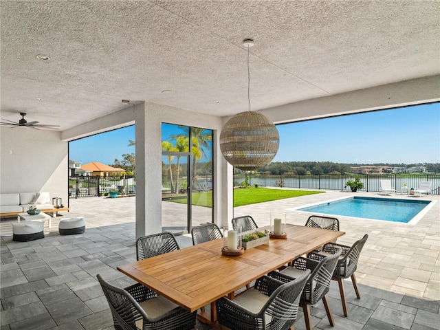 exterior space with a patio area, a water view, and ceiling fan