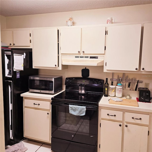 kitchen with black appliances, light tile patterned flooring, white cabinets, and a textured ceiling