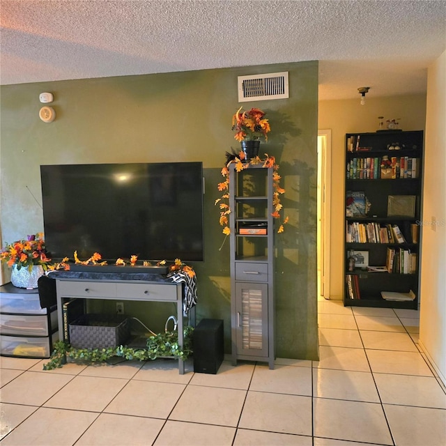 tiled living room with a textured ceiling