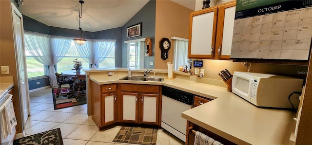 kitchen featuring white appliances, sink, light tile patterned flooring, kitchen peninsula, and hanging light fixtures