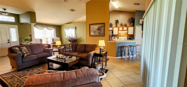 living room with lofted ceiling and light tile patterned flooring