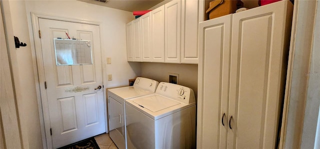 washroom featuring light tile patterned flooring, washer and dryer, and cabinets