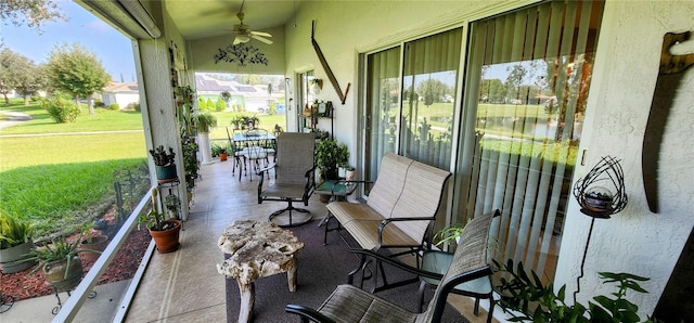 sunroom / solarium featuring ceiling fan and vaulted ceiling