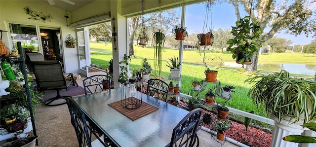 sunroom / solarium with a water view