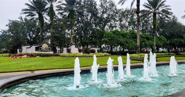 view of pool featuring a lawn