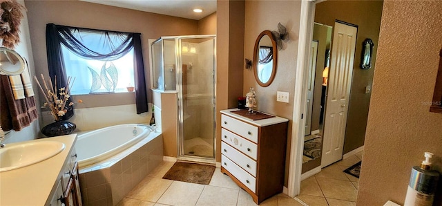 bathroom featuring tile patterned flooring, vanity, and plus walk in shower