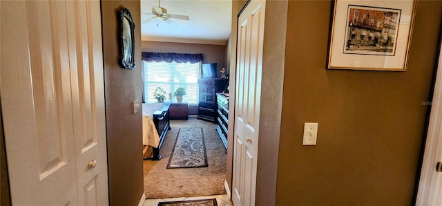 hallway featuring light carpet