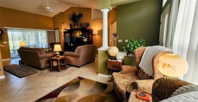 living room featuring ceiling fan, light tile patterned flooring, ornate columns, and high vaulted ceiling